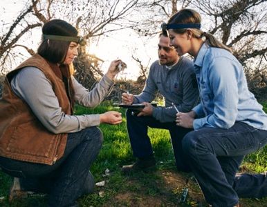 Three people eating outside